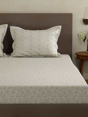 Bed with patterned bedding and pillows in a bedroom setting