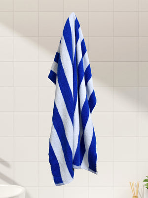 Blue and white striped towel hanging on a tiled wall